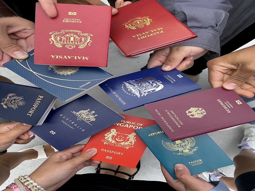 A passport, boarding pass, and travel gear at an airport gate